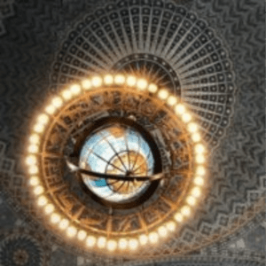 Beautiful round ceiling lamp fixture in the design of a globe surrounded by white lights in the Los Angeles Central Library Rotunda.